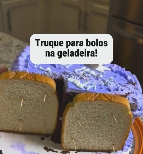bolo de aniversário com cobertura roxa na geladeira com fatias de pão de forma presas com palitos de dente nas laterais cortadas