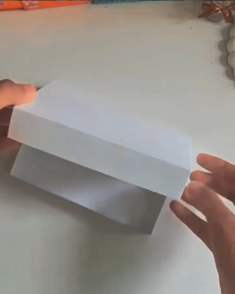 embalagem de presente artesanal feita com papel e régua dobrada em formato de caixa